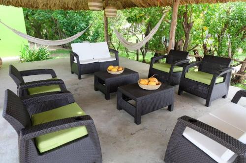 a group of chairs and tables on a patio at Cabaña en primera línea de playa en San Antero con Aire AC y 5 habitaciones in San Antero