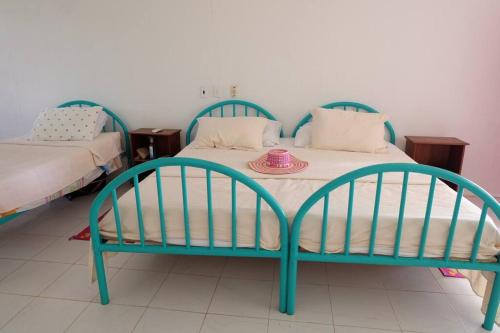 a blue bed with a plate on top of it at Cabaña en primera línea de playa en San Antero con Aire AC y 5 habitaciones in San Antero