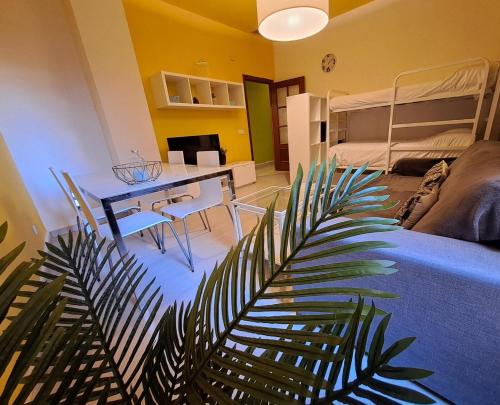 a living room with a table and a bed at Nest Style Granada in Granada