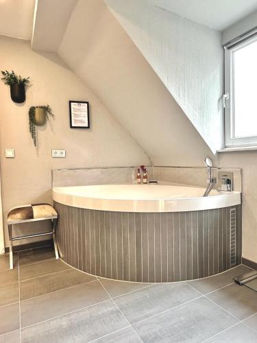 a bathroom with a large tub in a attic at 65qm Luxus Apartment mit Whirlpool Saarbrücken Uni Nähe in Saarbrücken