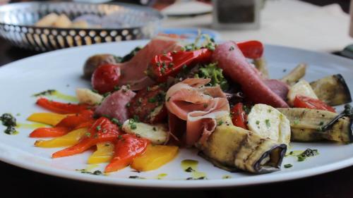 a plate of food with meat and vegetables on a table at Gasthof Zur Krone in Leidersbach