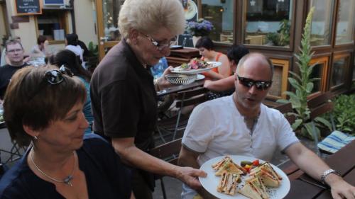 a man and a woman holding a plate of food at Gasthof Zur Krone in Leidersbach