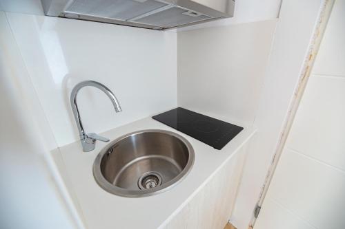 a sink in a tiny kitchen in a tiny house at Agi Castell Mar in Roses