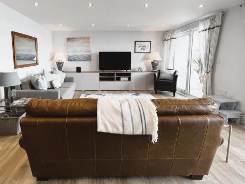 a living room with a couch and a television at 25 Breakwaters - Pet friendly in Sandown