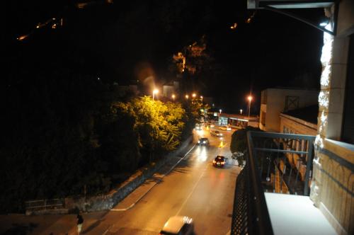 a city street at night with cars on the road at Hotel Porto In in Kotor