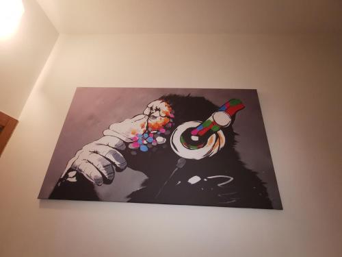 a picture hanging on a wall with a christmas picture at OSTIA HOME in Lido di Ostia