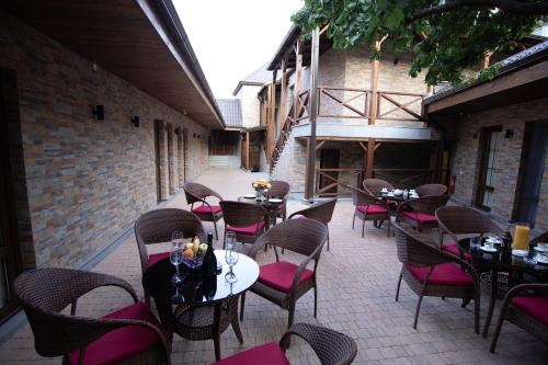 a patio with tables and chairs in a restaurant at BLH in Yerevan