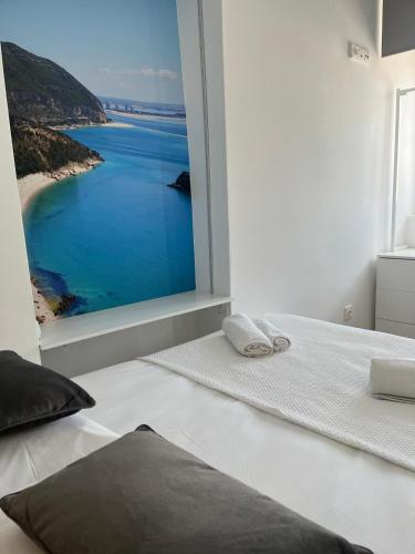 a bedroom with a view of the ocean at PÉROLA DA ARRÁBIDA - no coração de Setúbal in Setúbal