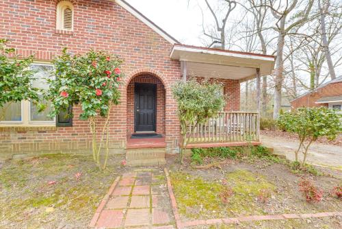 a brick house with a black door and a porch at Sanford Vacation Rental about 1 Mi to Downtown! in Sanford