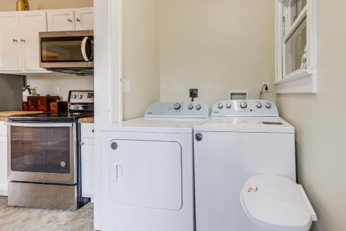 a kitchen with two washers and a stove at Sanford Vacation Rental about 1 Mi to Downtown! in Sanford