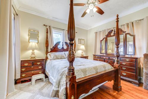 a bedroom with a bed and two dressers and a fan at Sanford Vacation Rental about 1 Mi to Downtown! in Sanford