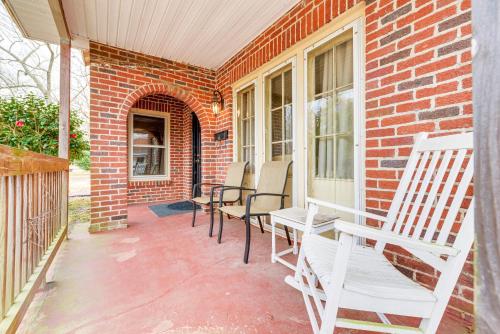 a porch with chairs and a table and a brick building at Sanford Vacation Rental about 1 Mi to Downtown! in Sanford