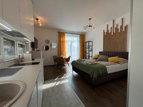 a bedroom with a bed and a kitchen at Hillside Central Apartments in Budapest