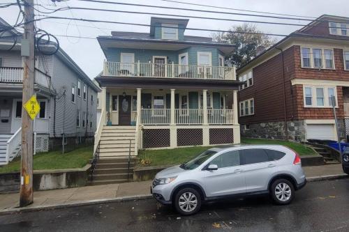 a silver car parked in front of a house at Modern Haven ,Your Stylish Retreat in Boston