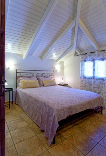 a bedroom with a large bed in a room at Villa Renata & Magic Suite in Parga