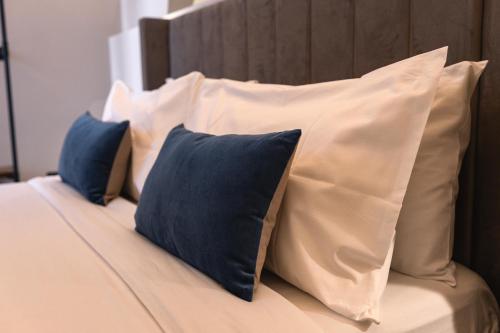 a bed with blue and white pillows on it at Calumidda in Catania