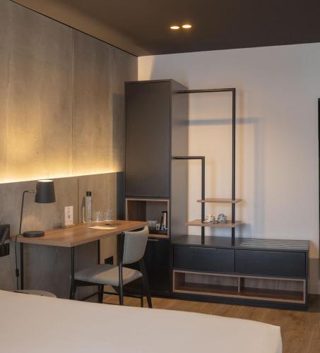 a kitchen with a table and chairs in a room at Hotel Tayko Bilbao in Bilbao