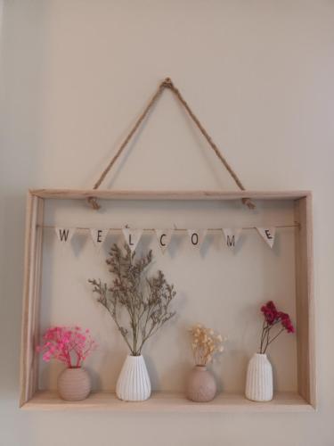 a shelf with three vases and flowers on it at Mulberry Lodge in Blarney