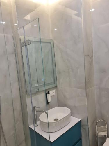 a bathroom with a sink and a mirror at Star Hotel in Tirana