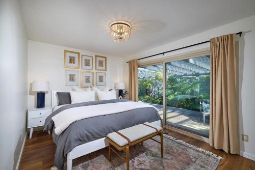 a bedroom with a large bed and a large window at Family Beach house in Carlsbad