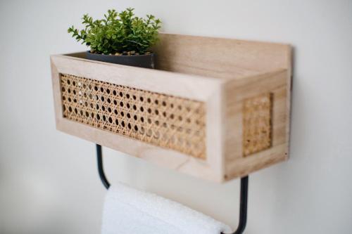 a wooden planter with two plants on a wall at Leeds getaway with hot tub & gaming room in Wakefield