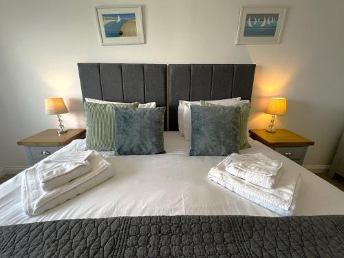 a bedroom with a large bed with two towels on it at Belle Vue in Sandown
