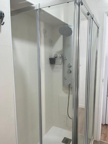 a shower with a glass door in a bathroom at PÉROLA DO BOCAGE - no coração de Setúbal in Setúbal