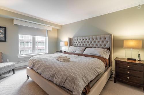 a bedroom with a large bed and a window at Lovely Waterfront Apt #807 with AC in Halifax