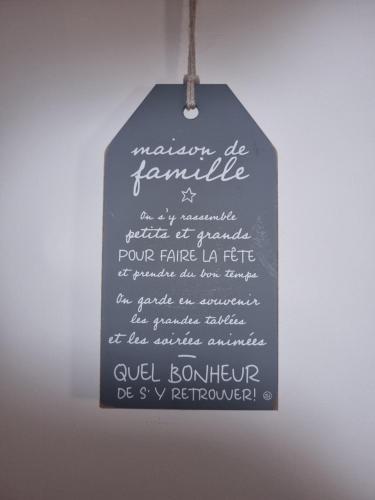 a hanging chalkboard sign with writing on it at coustelline in Le Lavandou