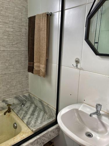 a bathroom with a shower and a sink and a tub at C-house in Ubatuba