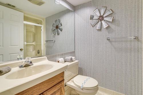 a bathroom with a sink and a toilet and a mirror at Lake Harmony Condo with Big Boulder Lake Views in Lake Harmony