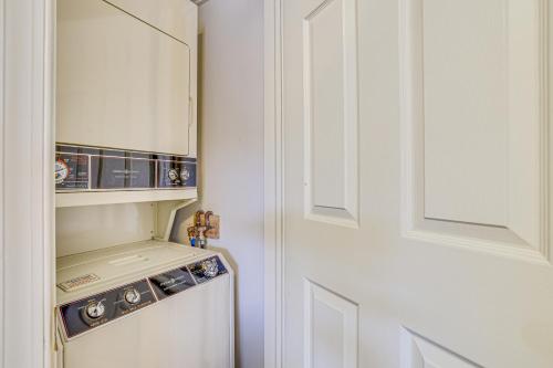 a white kitchen with a stove and a door at Lake Harmony Condo with Big Boulder Lake Views in Lake Harmony