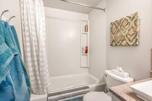 a white bathroom with a tub and a toilet at The Lakeside Cabin with wide outside space #105 in West Kelowna