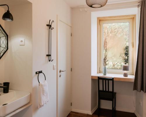 a bathroom with a sink and a window at Quinta da Quinhas in Vila Praia de Âncora