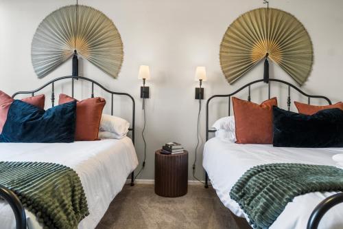two beds with pillows on them in a bedroom at DC Luxury Apartment Near Metro in Arlington
