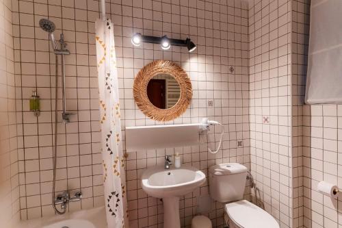 a bathroom with a sink and a toilet and a mirror at Rezident in Bucharest