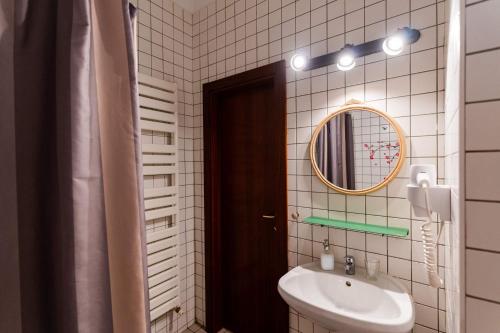 a bathroom with a sink and a mirror and a toilet at Rezident in Bucharest