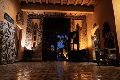 an entrance to a building with a door open at Kasbah Hotel Xaluca Arfoud in Erfoud