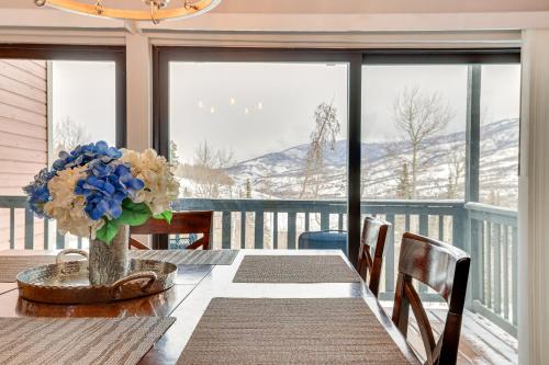 a dining room table with a vase of flowers on it at Ski, Shred and Tube Mtn-View Condo in Silverthrone! in Silverthorne