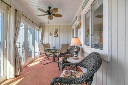 a screened in porch with chairs and a table at Sea-Nic View in Caswell Beach