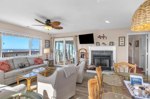a living room with a couch and a fireplace at Sea-Nic View in Caswell Beach