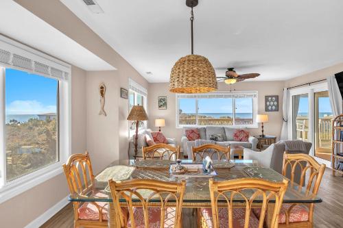 a dining room and living room with a table and chairs at Sea-Nic View in Caswell Beach