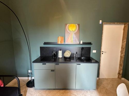 a kitchen with a counter with a sink at Bari Holiday Garibaldi 74 in Bari