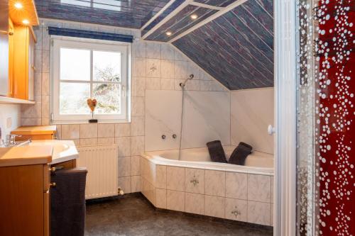 uma casa de banho com uma banheira e uma janela em Chalet Lercher em Goldegg