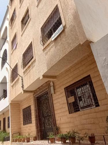 a building with a door and some plants in front of it at Apartment 20m from Martil beach in Tétouan