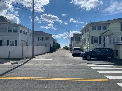 a street with houses and a car parked on the street at Island View Motel in Old Orchard Beach