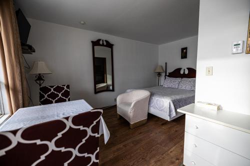 Ένα ή περισσότερα κρεβάτια σε δωμάτιο στο Motel Deblois