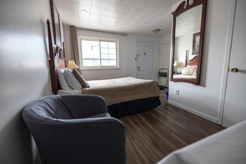 Ένα ή περισσότερα κρεβάτια σε δωμάτιο στο Motel Deblois
