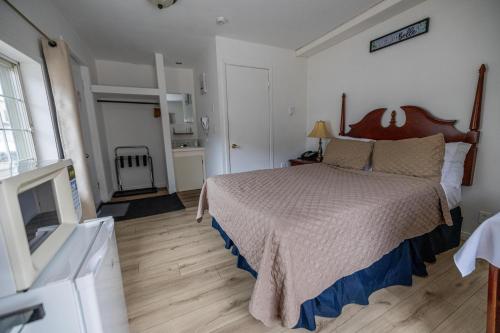 Ένα ή περισσότερα κρεβάτια σε δωμάτιο στο Motel Deblois