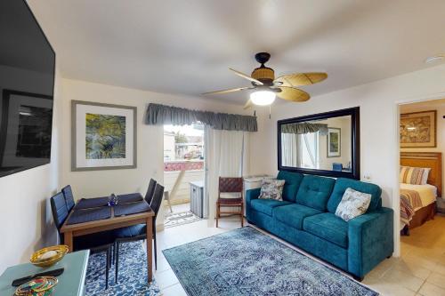 a living room with a couch and a table at Fairway Terrace G101 in Waikoloa Village